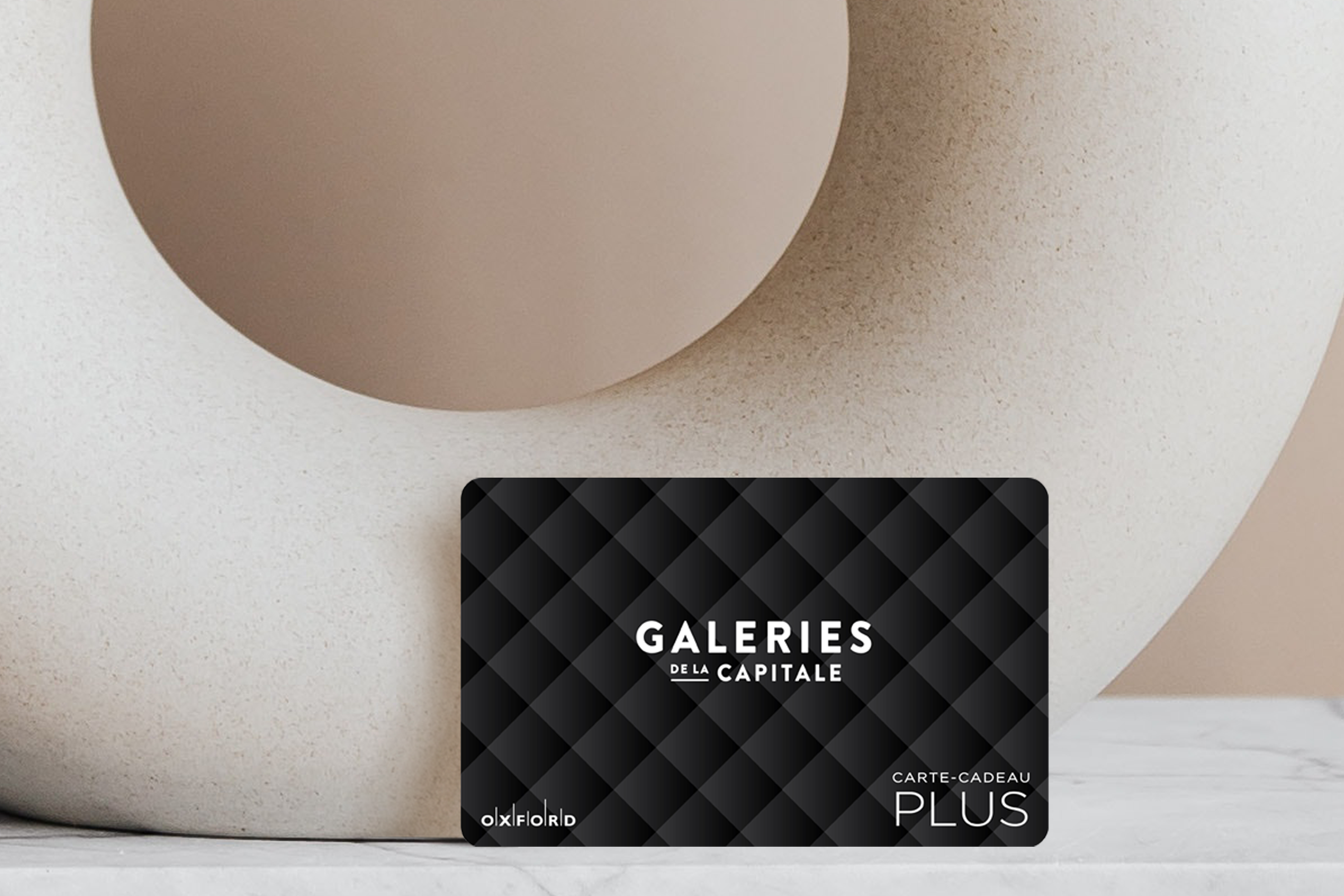 Capitale black gift card with beige circular vase.
